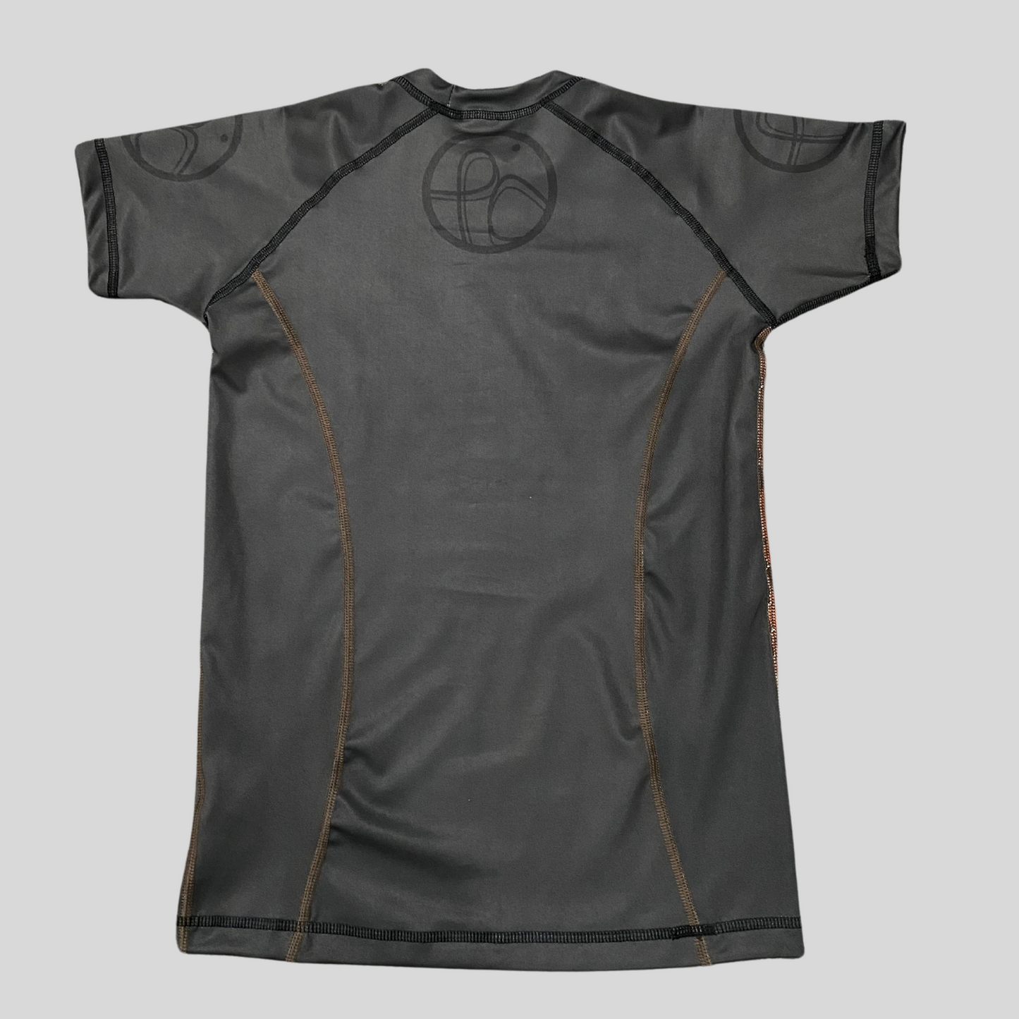 charcoal gray and brown stitching back rashguard featuring a sleek jaguar pattern, tailored for grapplers."