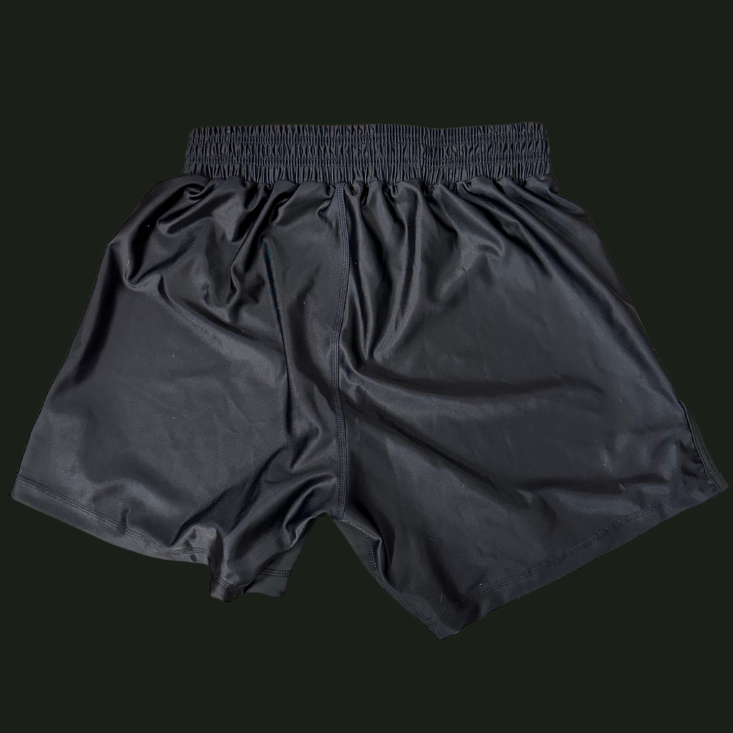 Black athletic shorts on a black background