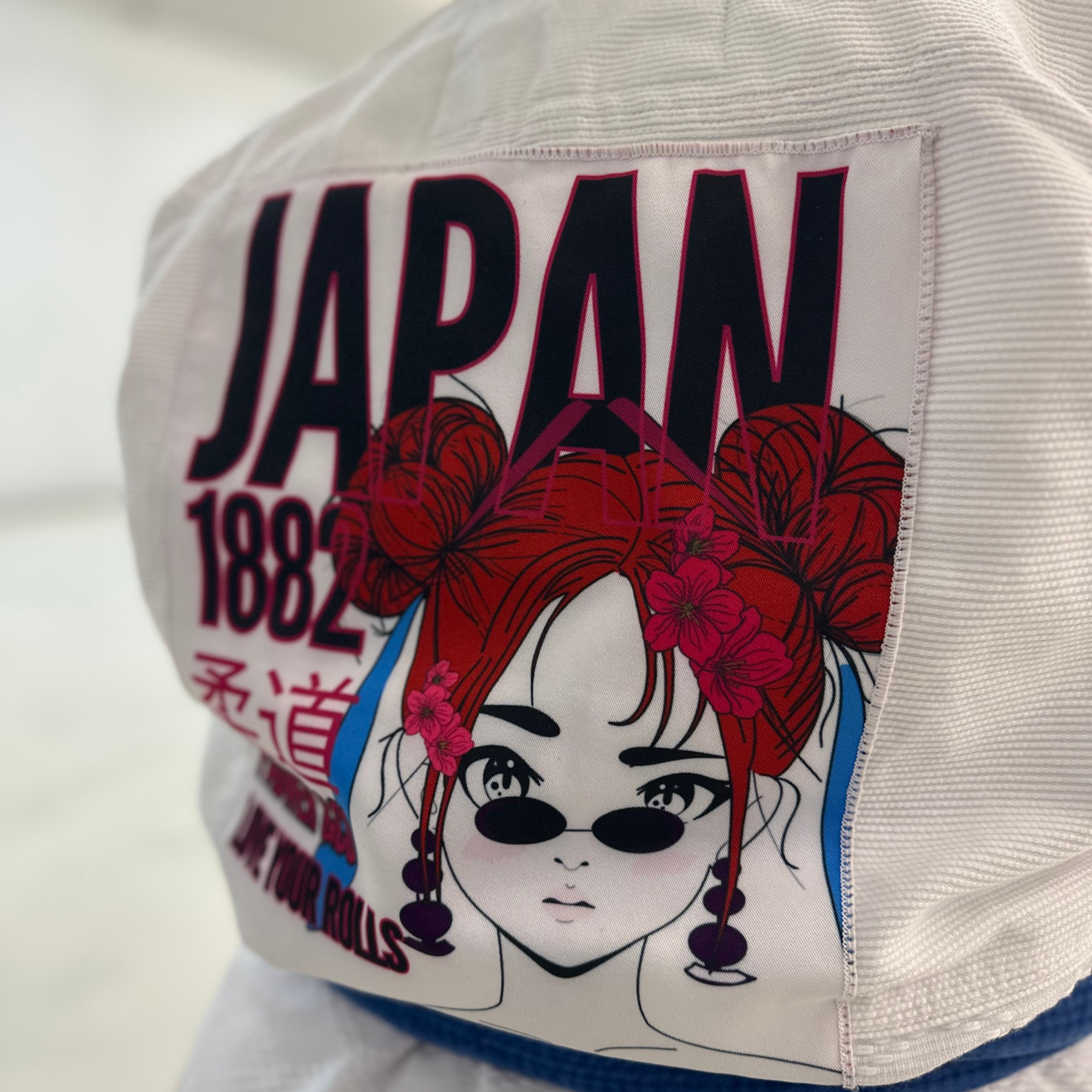 closed up picture of the pack located on the back of the white jacket showing the Judo inspiration