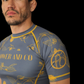 Man wearing a blue rashguard with gold koi fish  patterns and 'PAOWER AND CO' text.