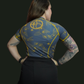 female posing showing the blue and gold rashguard from the back
