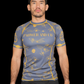Man wearing a blue athletic shirt with yellow patterns and paower and co text on the chest 
