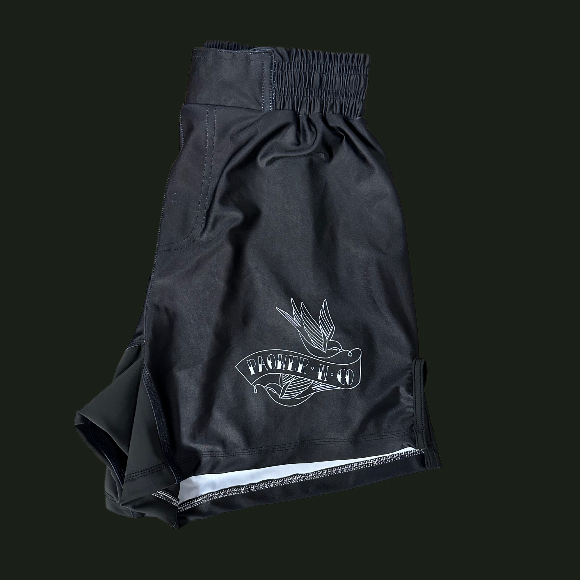Black shorts with a white logo on a black background